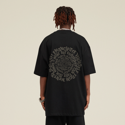 A person from behind wearing a Blackness Emancipation Tee with the phrase sentence Emancipate yourself from mental slavery. 