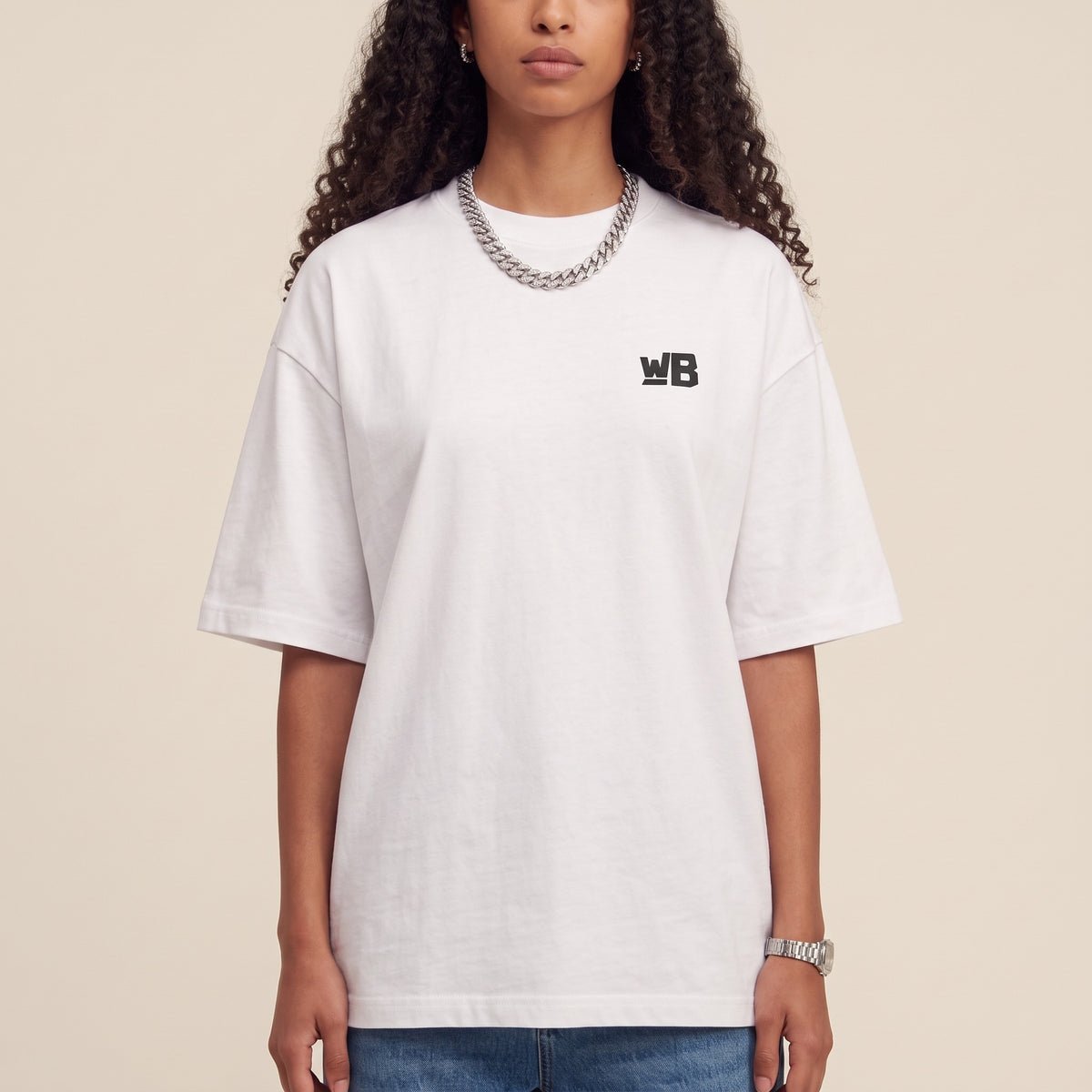 Base Blackness Tee White — close-up of the WB monogram chest logo and ribbed collar, oversized heavyweight cotton streetwear tee by We Are Blackness