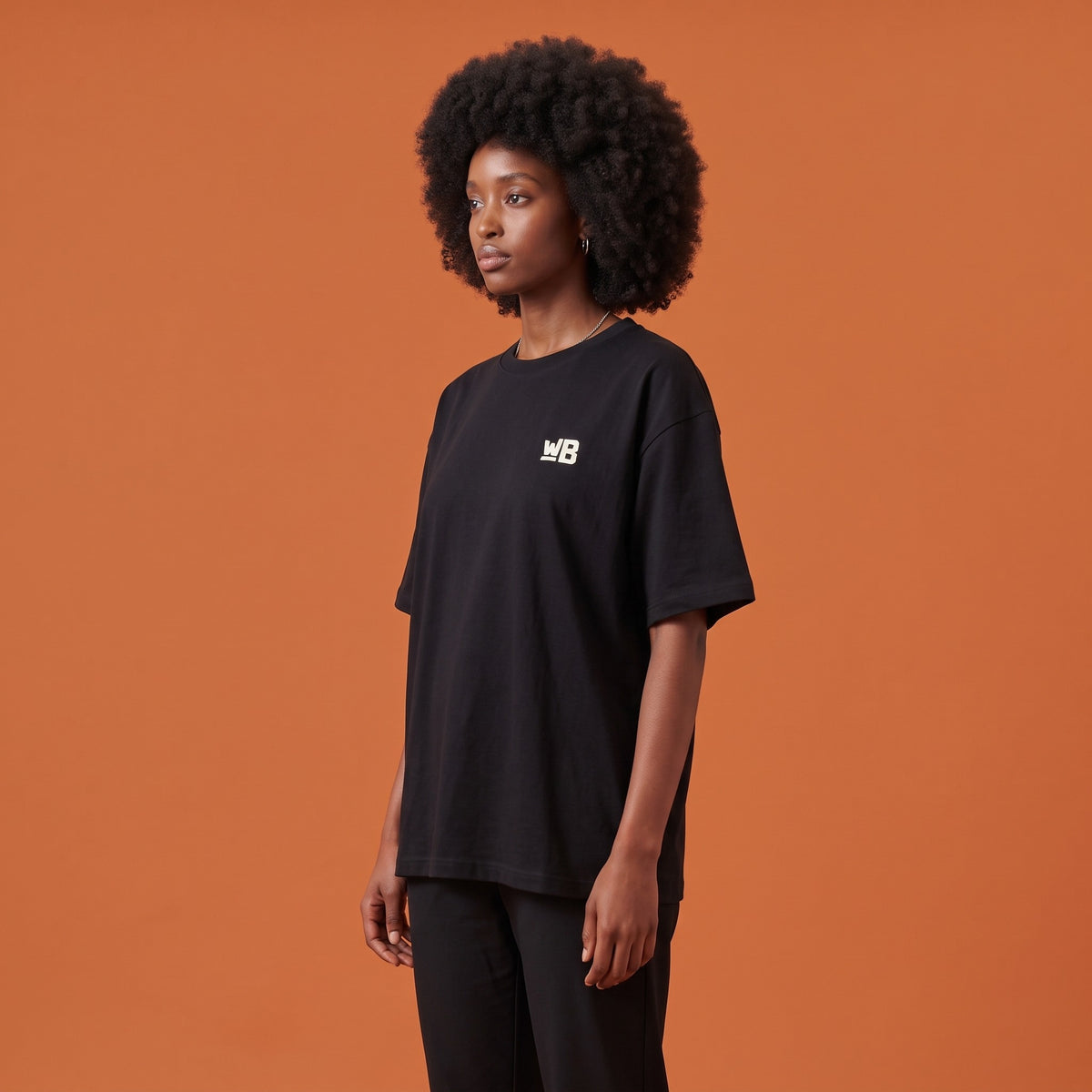 Blackness Libation Tee Black — side view of the drop-shoulder sleeve and boxy oversized fit, oversized heavyweight cotton streetwear tee by We Are Blackness