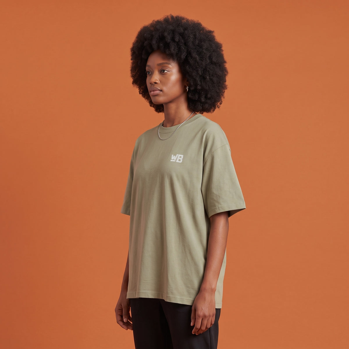 Blackness Libation Tee Brown Khaki — side view of the drop-shoulder sleeve and boxy oversized fit, oversized heavyweight cotton streetwear tee by We Are Blackness