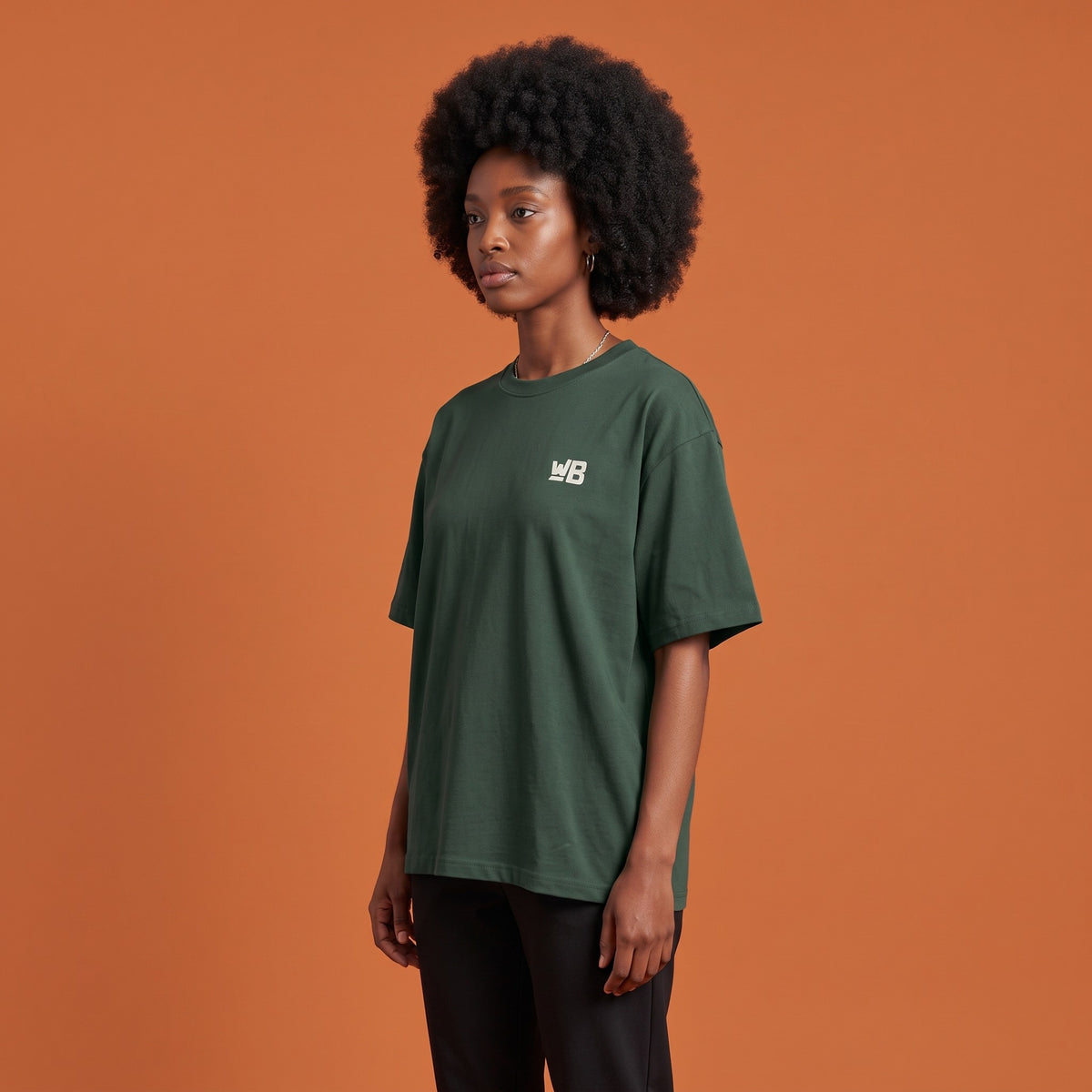 Blackness Libation Tee Forest Green — side view of the drop-shoulder sleeve and boxy oversized fit, oversized heavyweight cotton streetwear tee by We Are Blackness