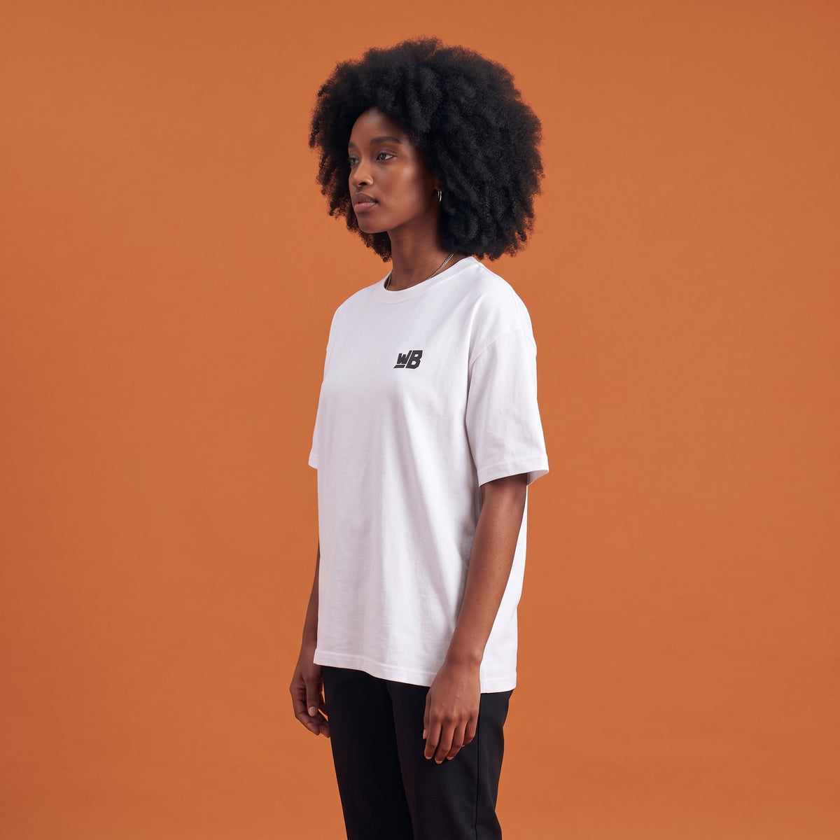 Blackness Libation Tee White — side view of the drop-shoulder sleeve and boxy oversized fit, oversized heavyweight cotton streetwear tee by We Are Blackness