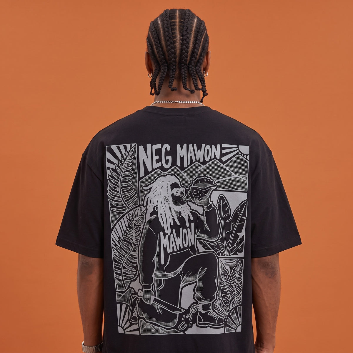 Blackness Mawon Tee Black — close-up of the Neg Mawon conch-blower linocut back print worn on the back, oversized heavyweight cotton streetwear tee by We Are Blackness