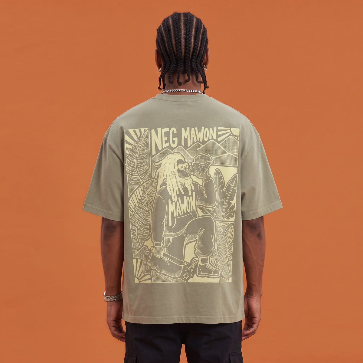 Blackness Mawon Tee Brown Khaki — close-up of the Neg Mawon conch-blower linocut back print worn on the back, oversized heavyweight cotton streetwear tee by We Are Blackness