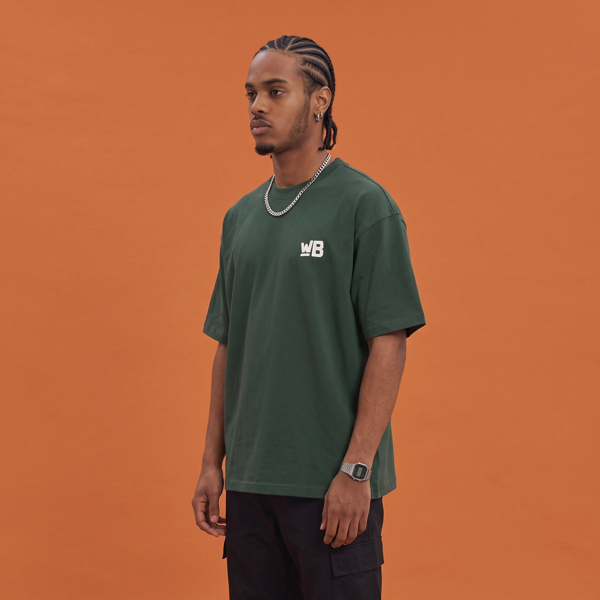 Blackness Mawon Tee Forest Green — side view of the drop-shoulder sleeve and boxy oversized fit, oversized heavyweight cotton streetwear tee by We Are Blackness