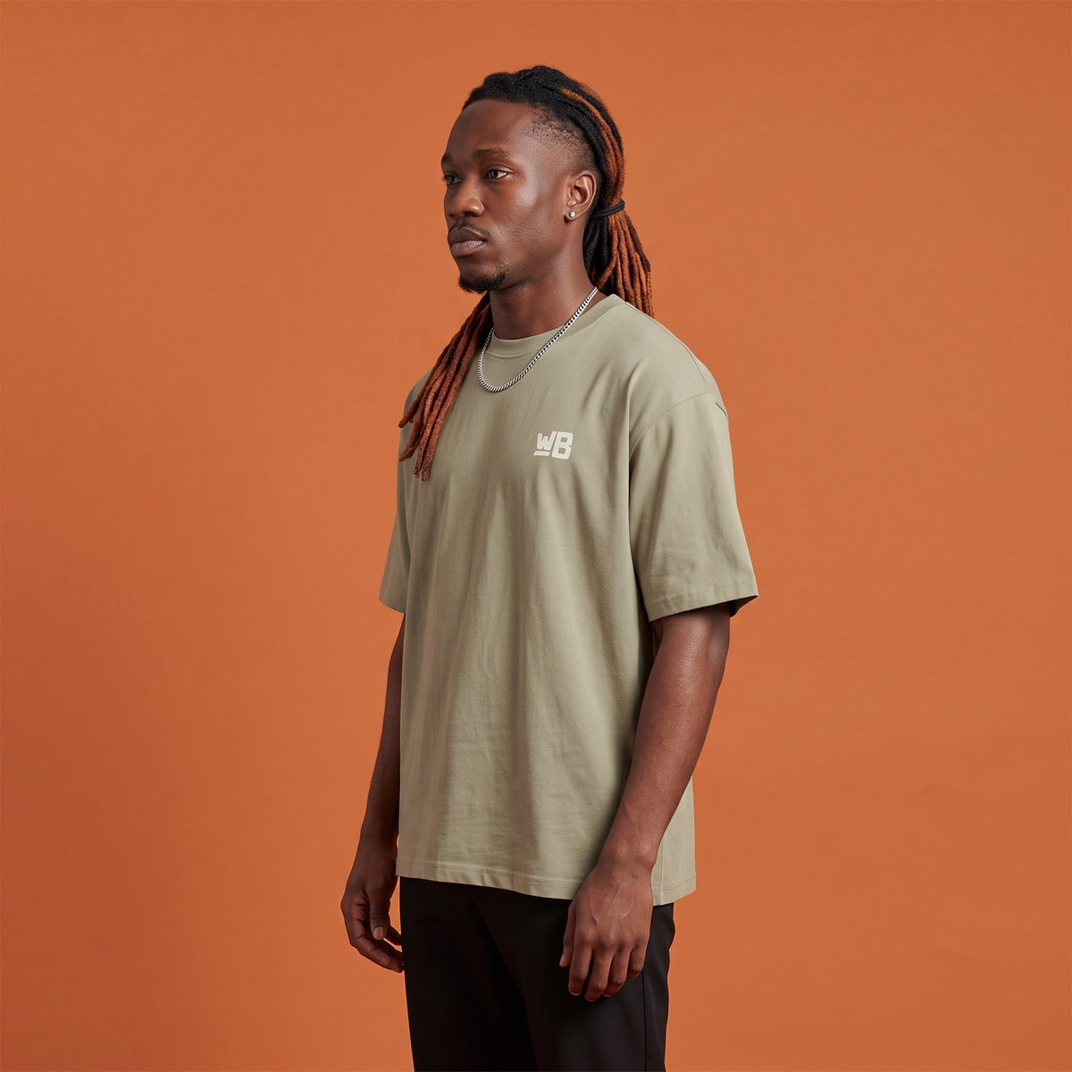 Blackness Sodabi Tee Brown Khaki — side view of the drop-shoulder sleeve and boxy oversized fit, oversized heavyweight cotton streetwear tee by We Are Blackness