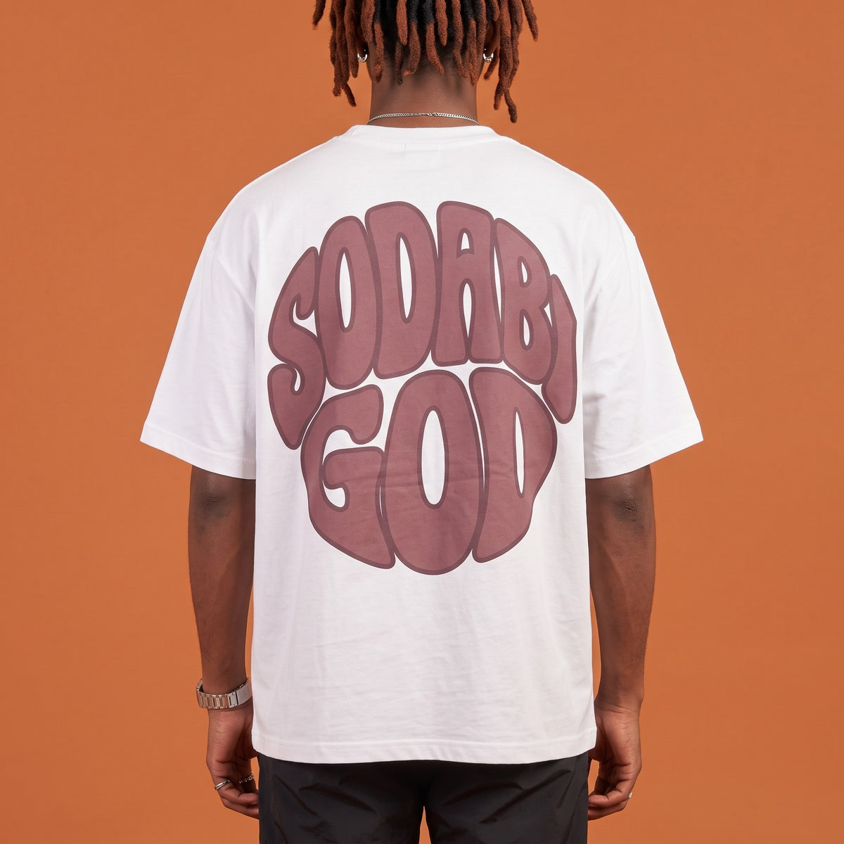 Blackness Sodabi Tee White — close-up of the SODABI GOD bubble-letter back print worn on the back, oversized heavyweight cotton streetwear tee by We Are Blackness