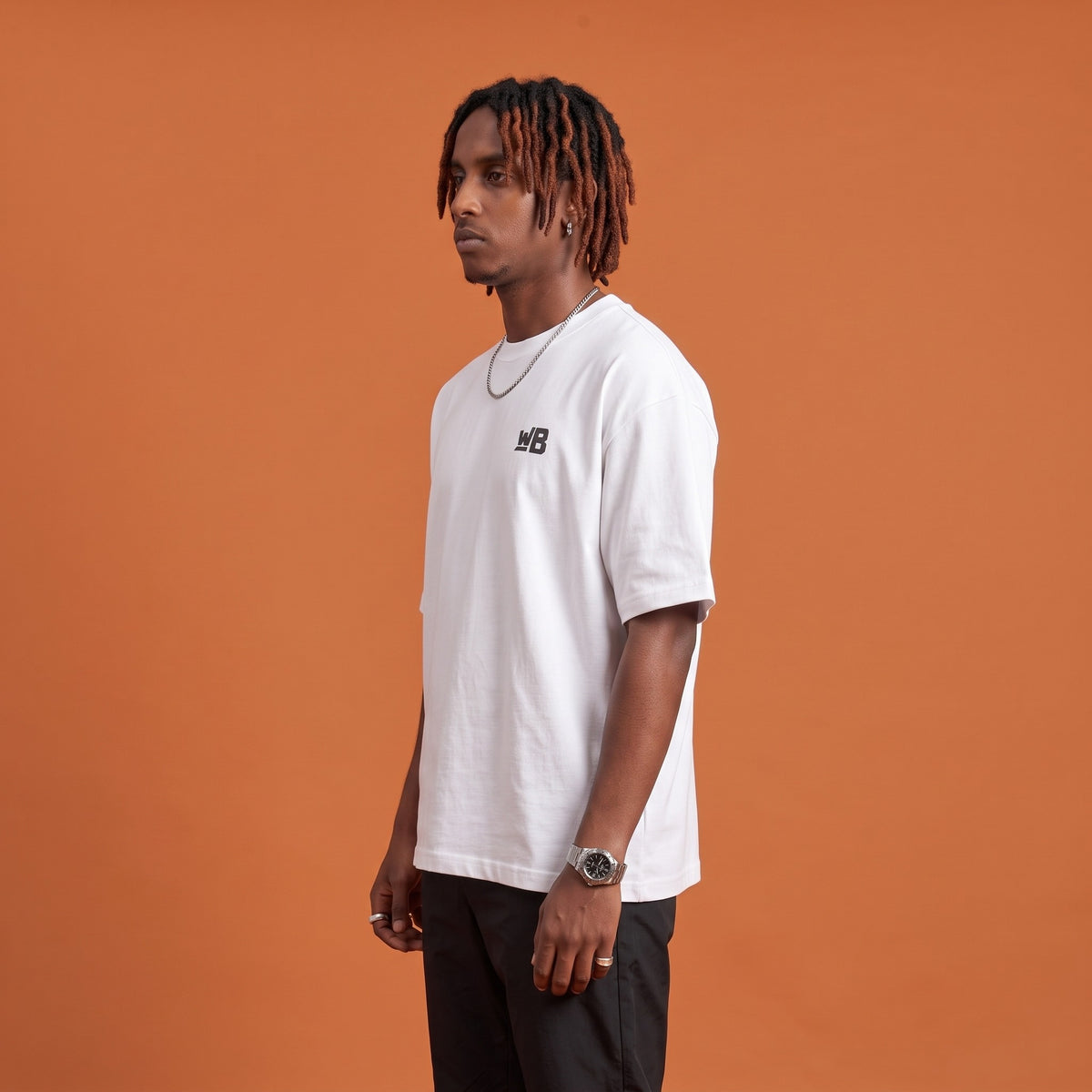 Blackness Sodabi Tee White — side view of the drop-shoulder sleeve and boxy oversized fit, oversized heavyweight cotton streetwear tee by We Are Blackness