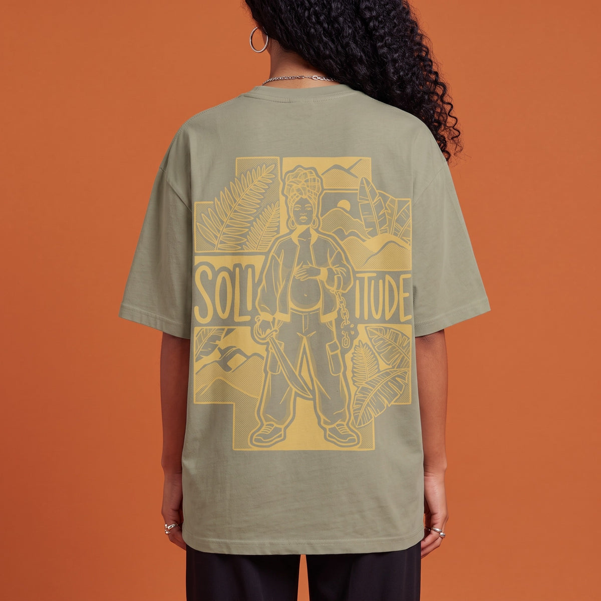 Blackness Solitude Tee Brown Khaki — close-up of the Solitude block-print portrait back graphic worn on the back, oversized heavyweight cotton streetwear tee by We Are Blackness