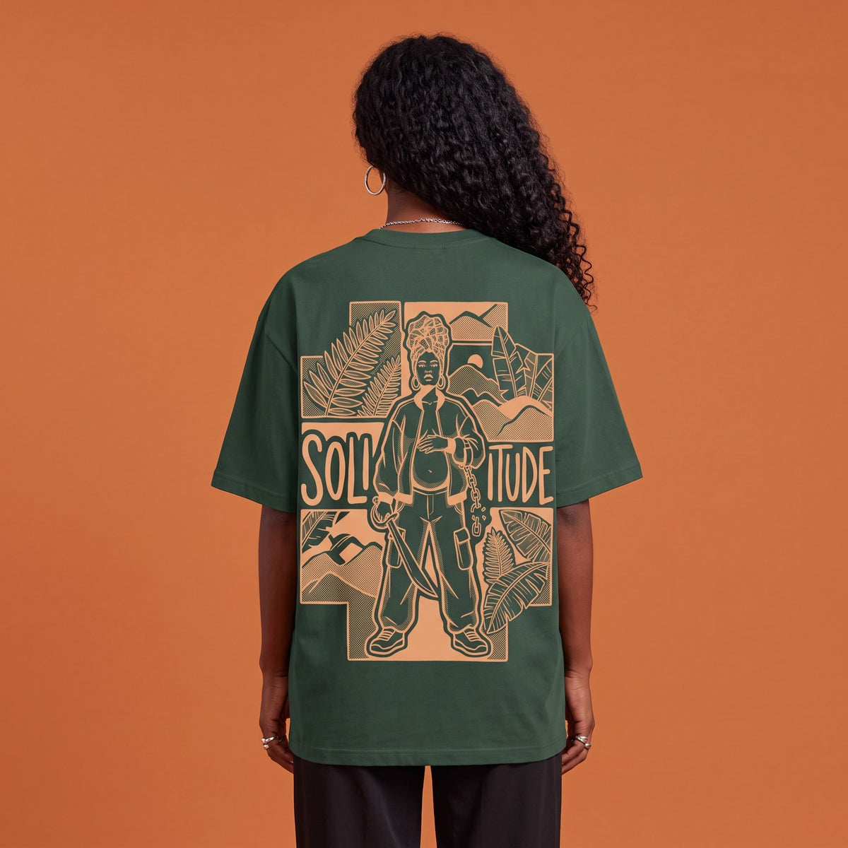 Blackness Solitude Tee Forest Green — close-up of the Solitude block-print portrait back graphic worn on the back, oversized heavyweight cotton streetwear tee by We Are Blackness