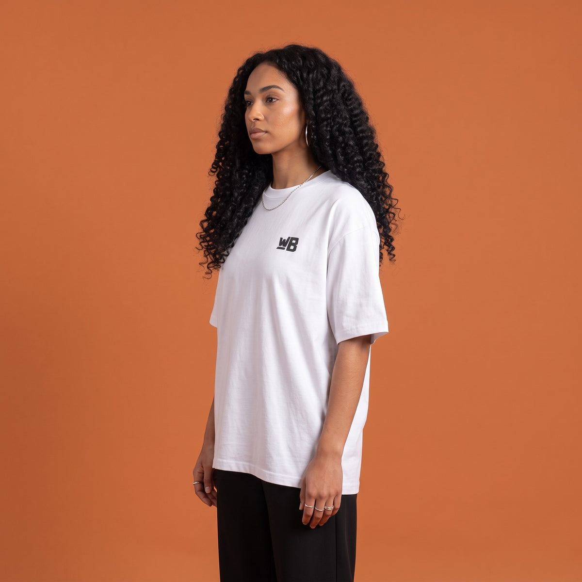 Blackness Solitude Tee White — side view of the drop-shoulder sleeve and boxy oversized fit, oversized heavyweight cotton streetwear tee by We Are Blackness