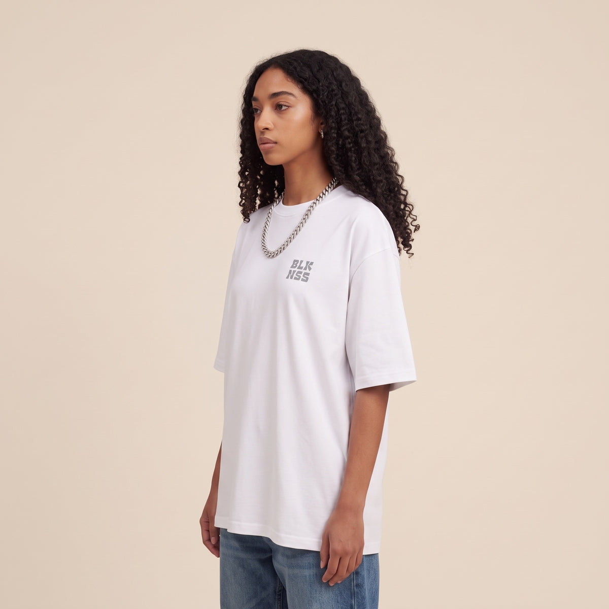 Blackness WABLKNSS Tee White — side view of the drop-shoulder sleeve and boxy oversized fit, oversized heavyweight cotton streetwear tee by We Are Blackness
