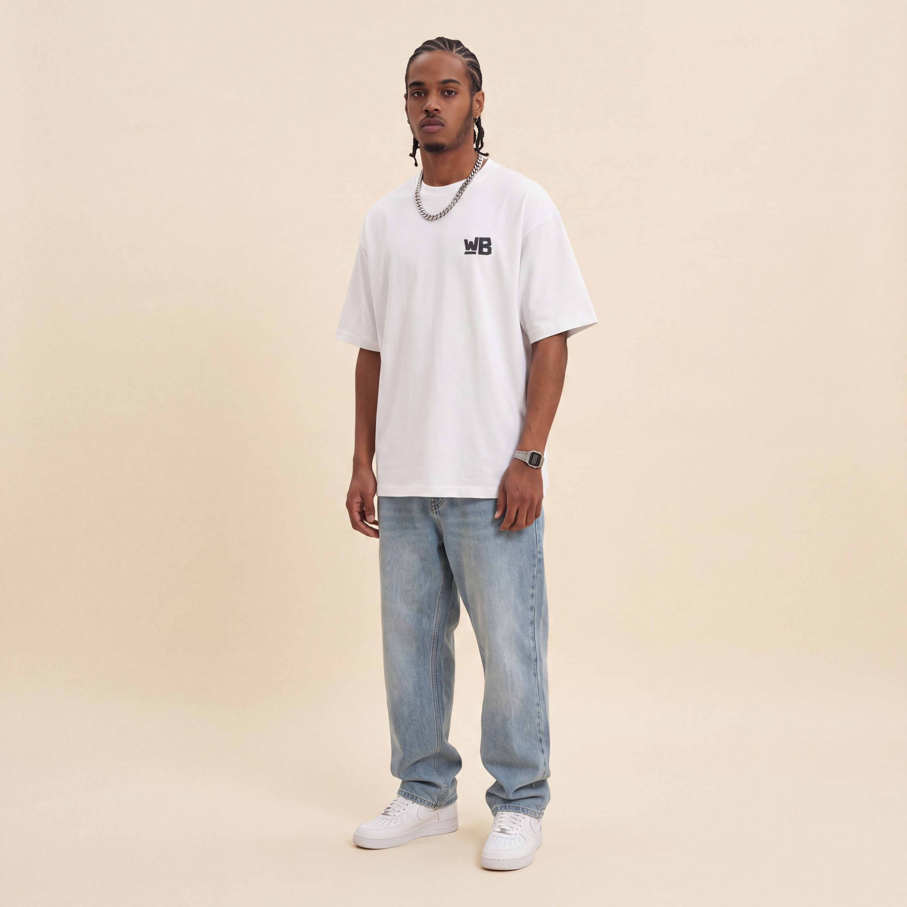 Blackness Emancipation Tee White worn by model, front view with WB chest logo on beige studio backdrop