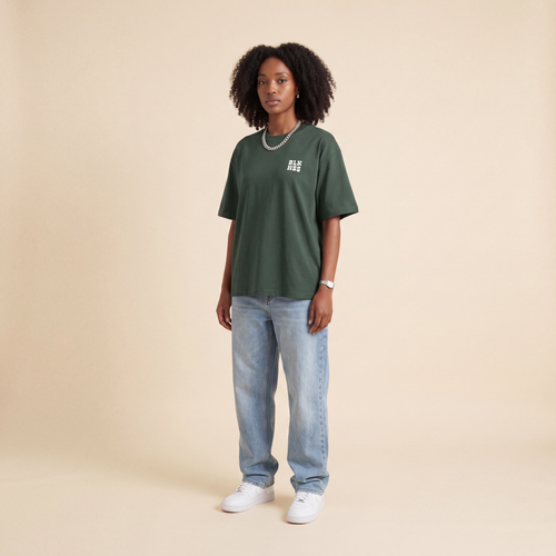 Blackness WABLKNSS Tee Green worn by model, front view on beige studio backdrop