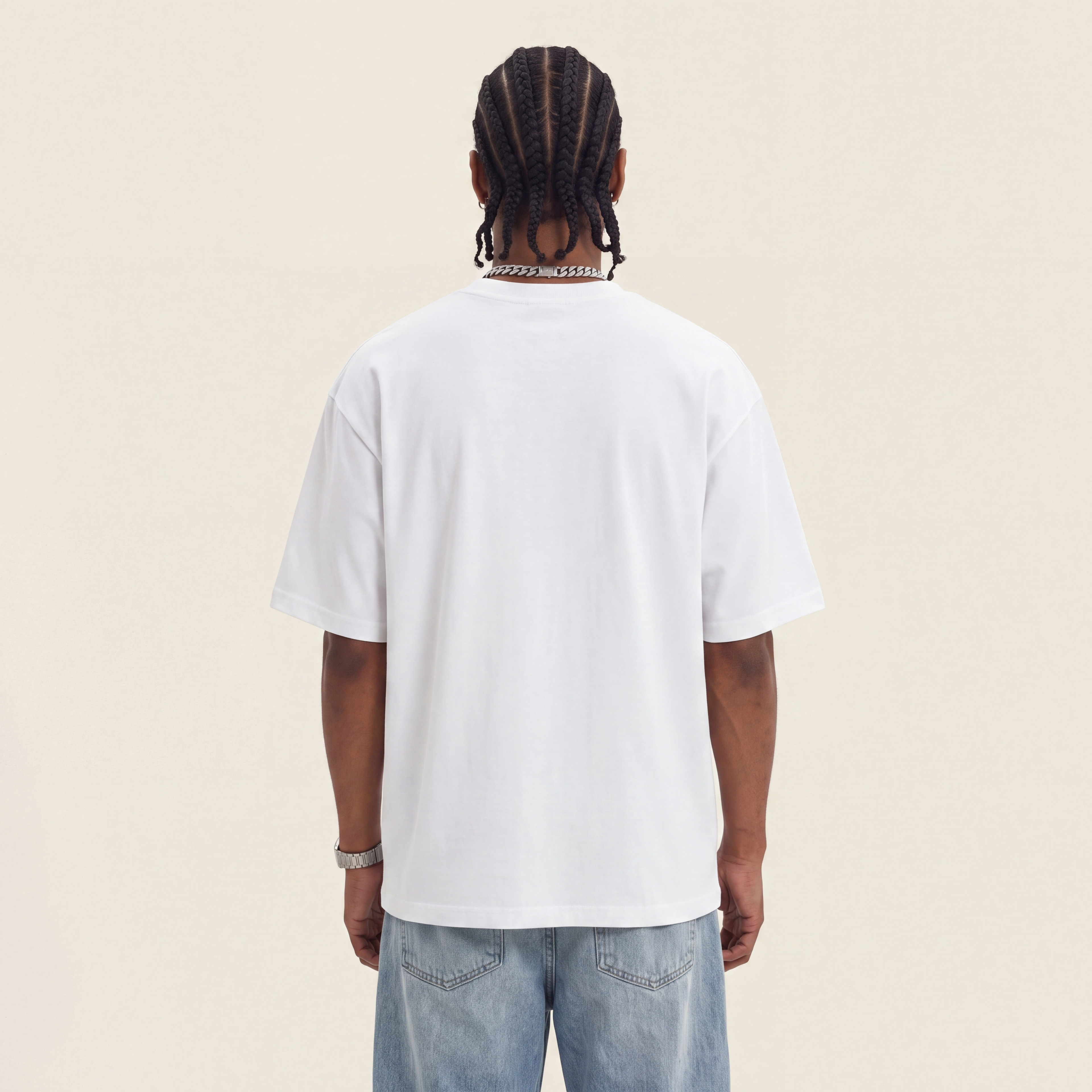Wear Blackness Tee White worn by model, back view showing the clean plain back on warm ivory studio backdrop