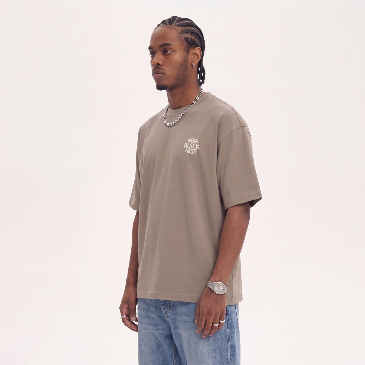Wear Blackness Tee Brown — side view of the drop-shoulder sleeve and boxy oversized fit, oversized heavyweight cotton streetwear tee by We Are Blackness